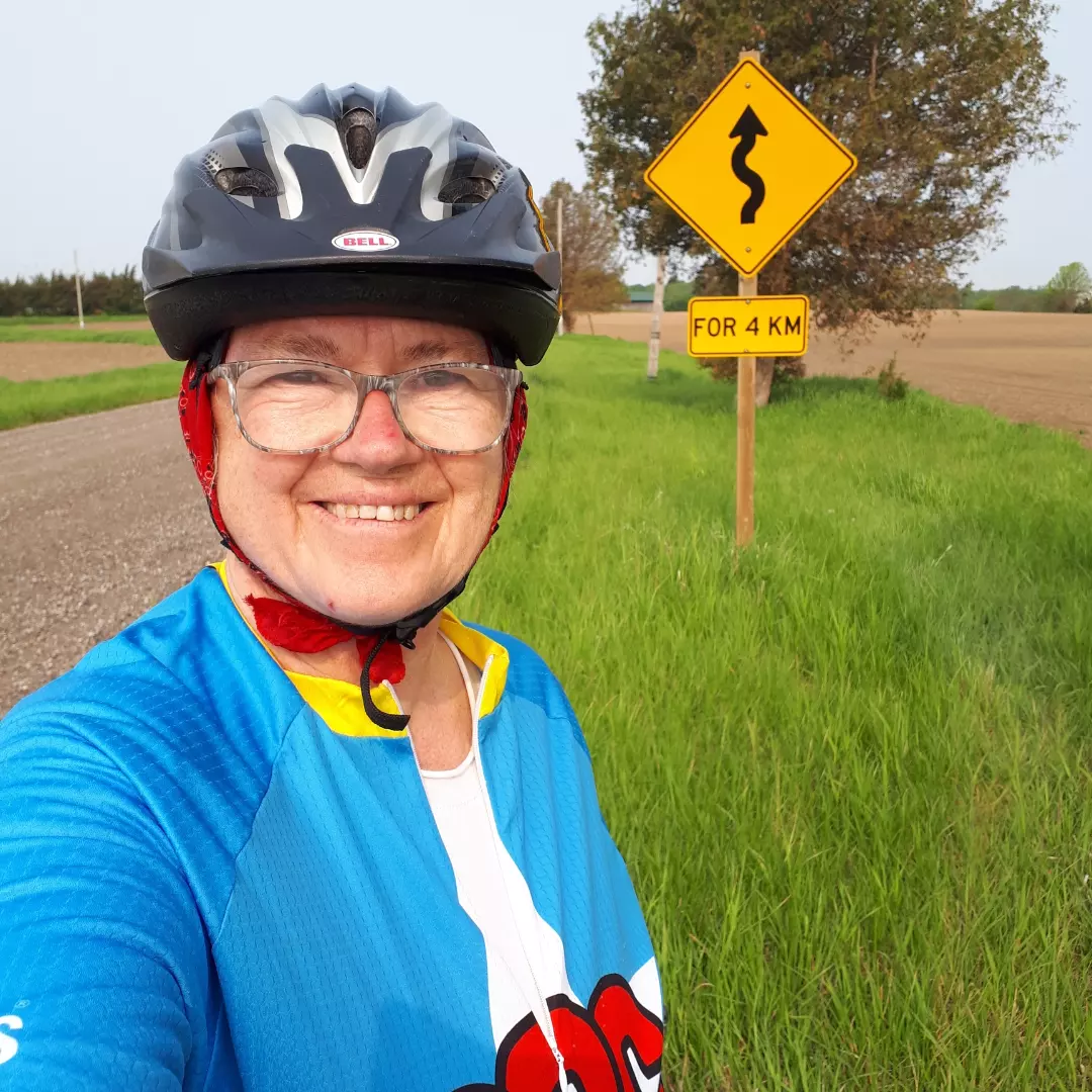 Back Road Cycling tours and clinics in southwestern Ontario are hosted by Susanne Spence Wilkins shown here on a winding gravel road in Chatham-Kent