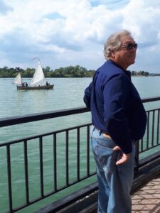 Man looking away from a old-time pirate ship on Detroit River 